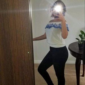 White off-shoulder shirt with blue designs